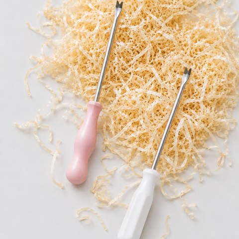 Wood wool filling and a stuffing tool